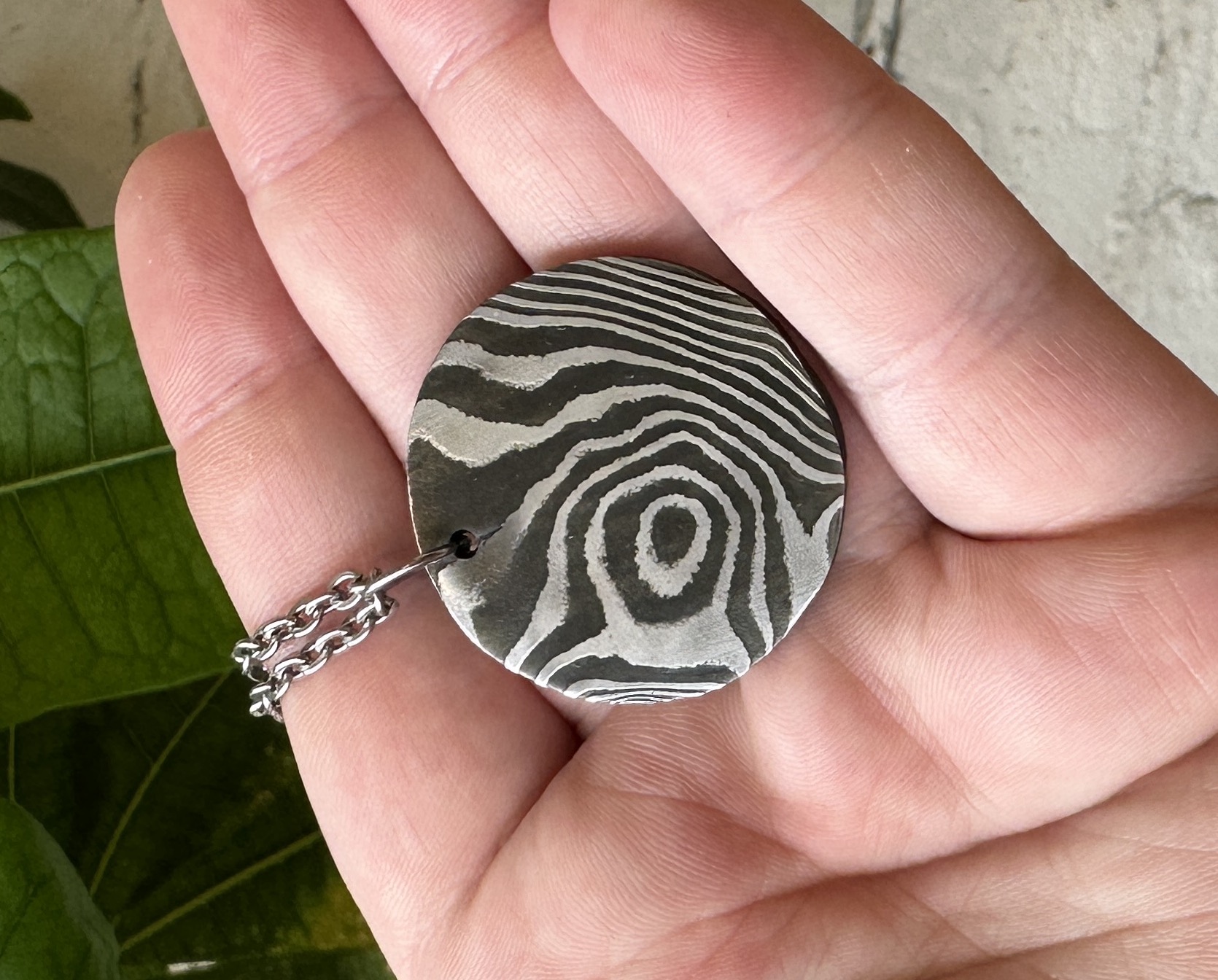 circular damascus steel pendant